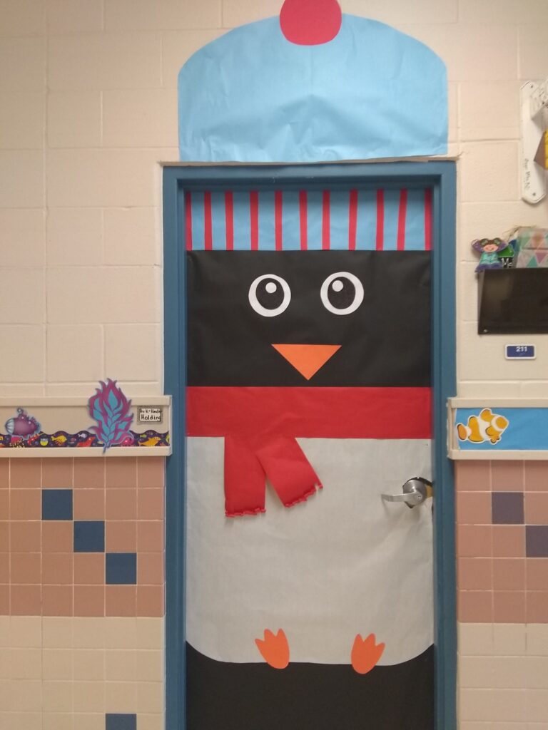 Sometimes the hardest part of Christmas door decorations is figuring out the idea.  In this post you will find plenty of inspiration from Elf Selfies to Gingerbread Houses to Grinch Acts of Kindness to Elf on the Shelf (and more)! #Christmas #2ndgrade #1stgrade #doordecorations 