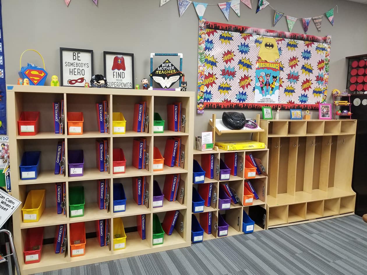 Superhero classroom display with comic-style signs and bright colors.