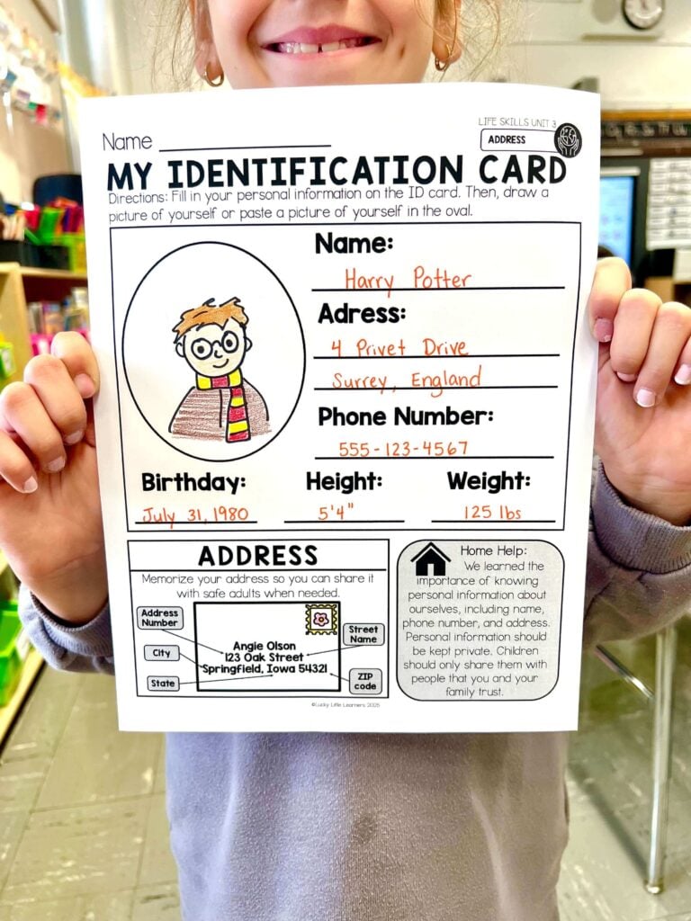 Image showing a student holding an ID card activity used to help kids learn address and phone number information by filling in personal details.