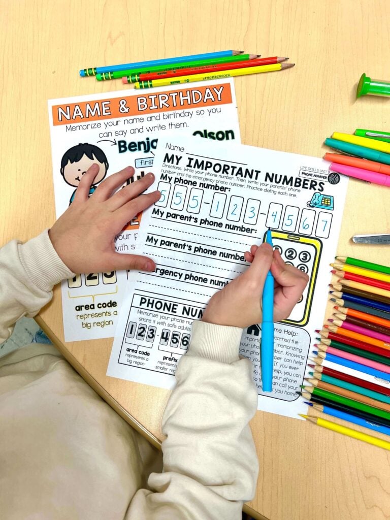 Image showing a student practicing how to learn address and phone number details by writing their important numbers on a life skills worksheet.