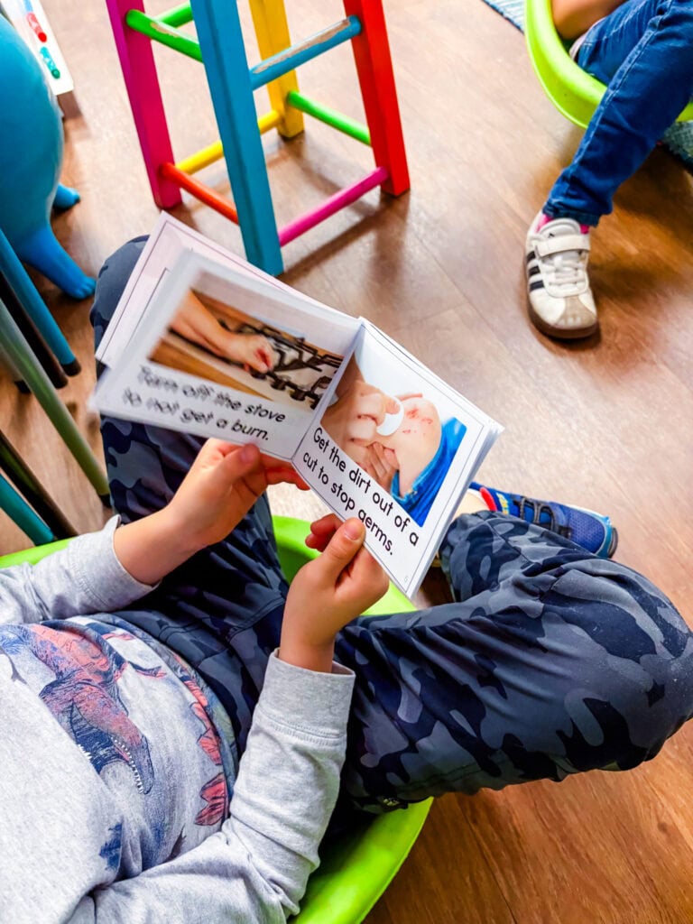 Image showing a student reading a small flip book with a partner during hands-on buddy reading activities.