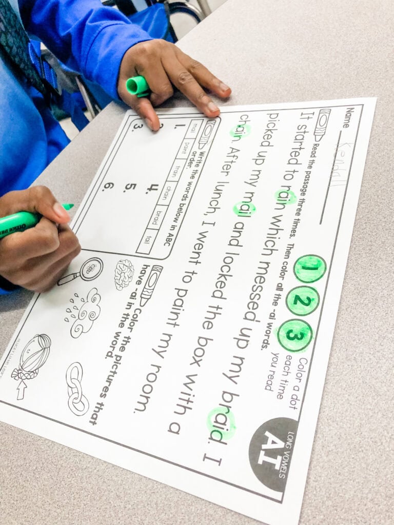 Image showing a student completing phonics writing and highlighting tasks that support fluency during buddy reading activities.