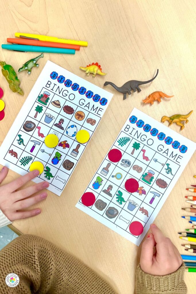 Students playing dinosaur bingo game during dinosaur day for first and second grade math center