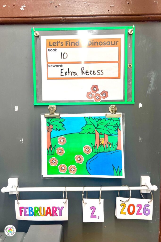 Dinosaur day for first and second grade classroom display with goal board, date cards, and find-the-dinosaur activity