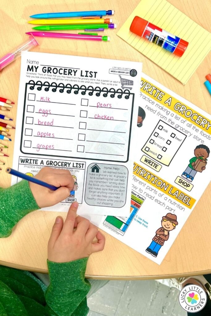 Student completing grocery list writing activity in a play kitchen K-2 classroom center