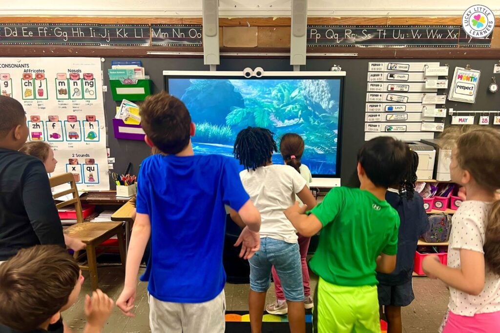 New kindergarten teacher classroom featuring students actively participating in an interactive lesson using a classroom smart board.